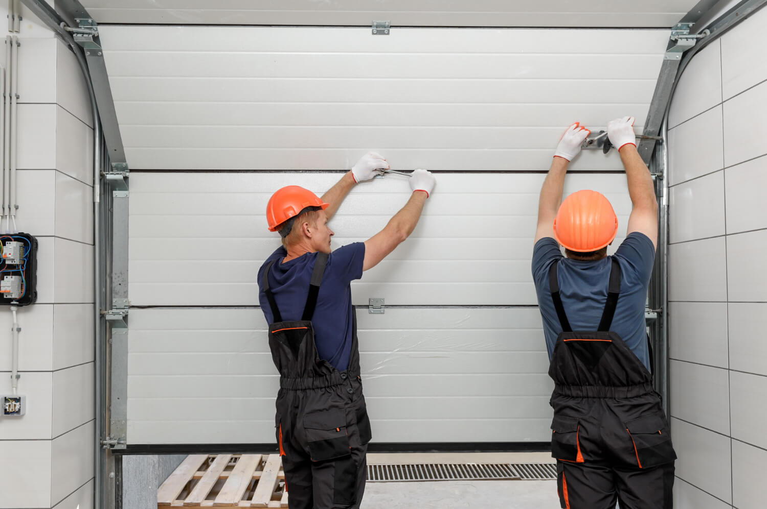 Technician repairing a garage door